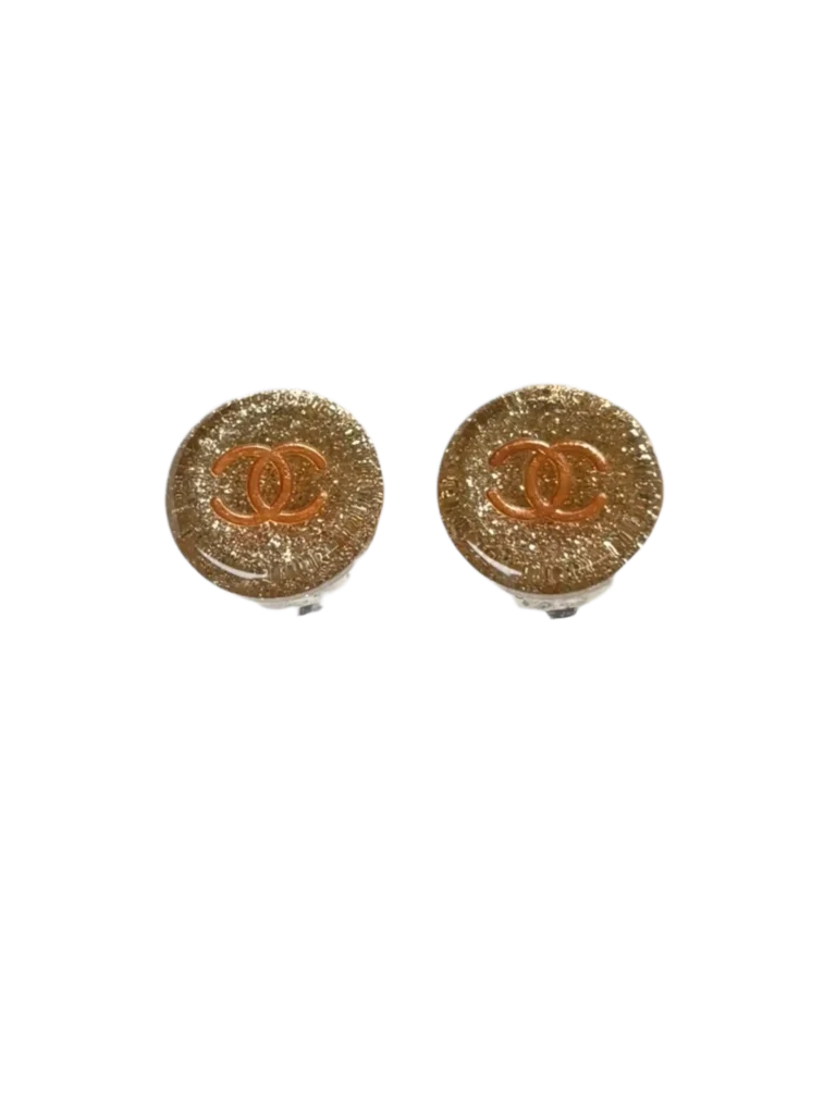 Round clip-on earrings with glitter CC logo.