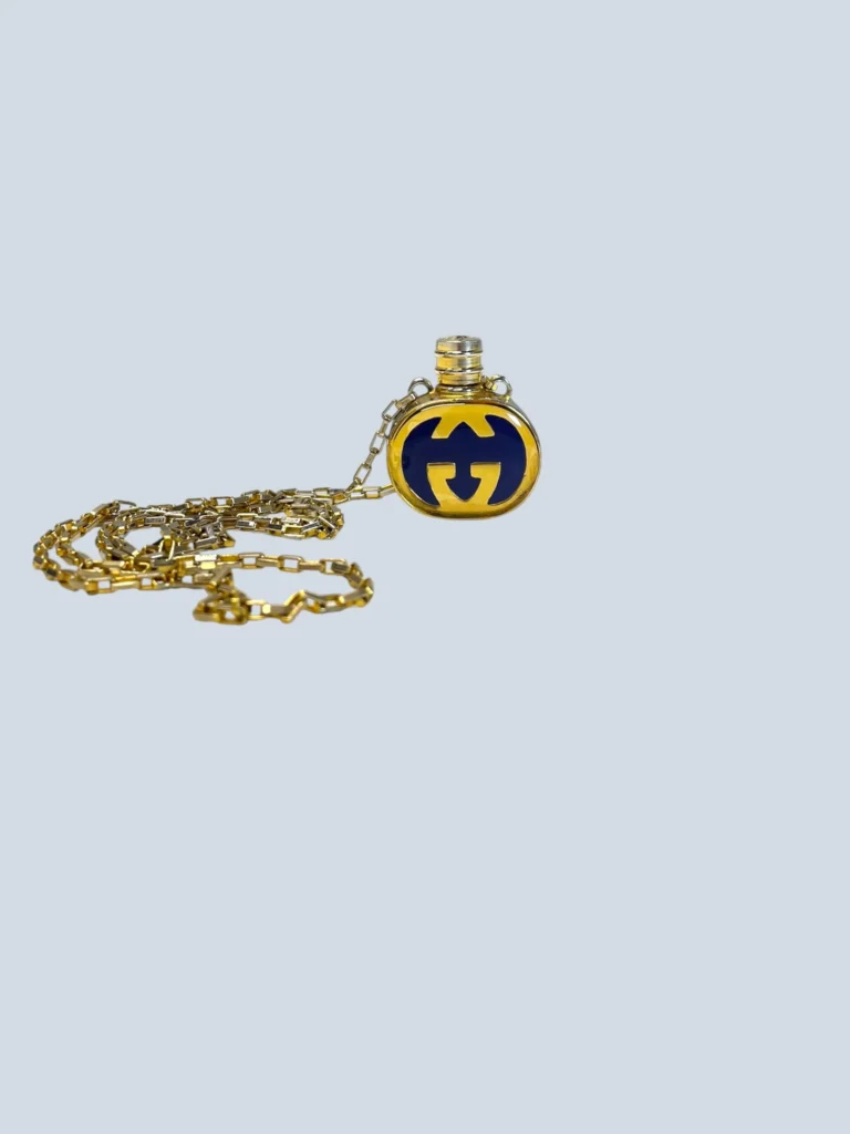 Vintage Gucci necklace with perfume and logo pendant.