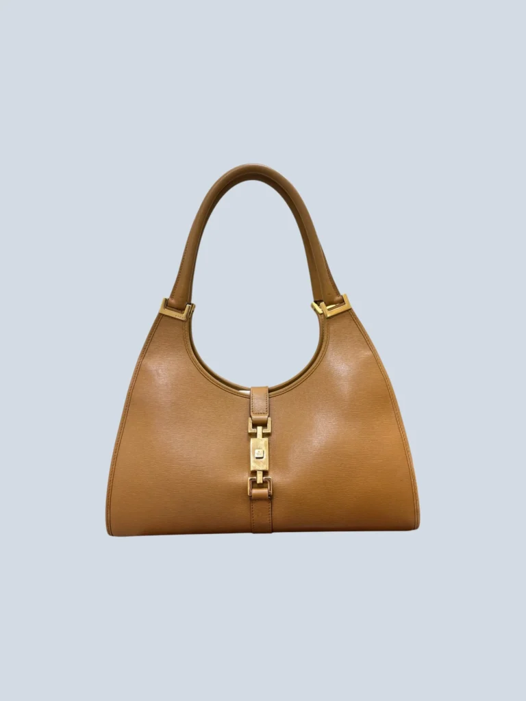 Gucci Bardot brown leather shoulder bag front view with gold buckle.