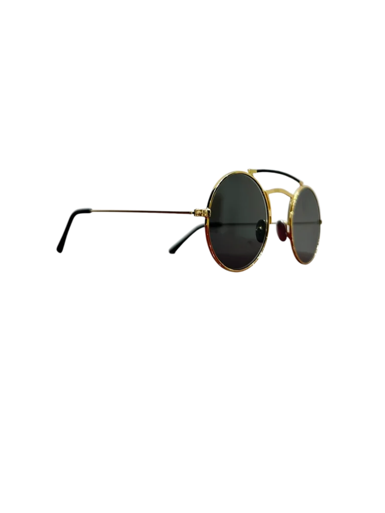 Christopher Kane round sunglasses in gold-tone metal and black leather, side view with dark lenses.