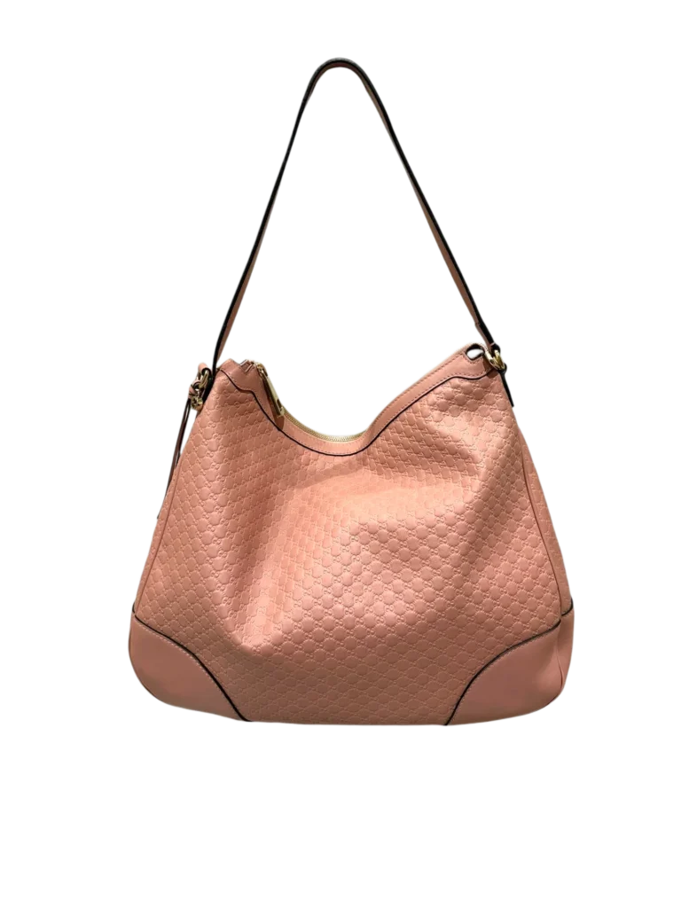 Borsa a spalla Gucci in pelle rosa con motivo Guccissima, vista frontale.